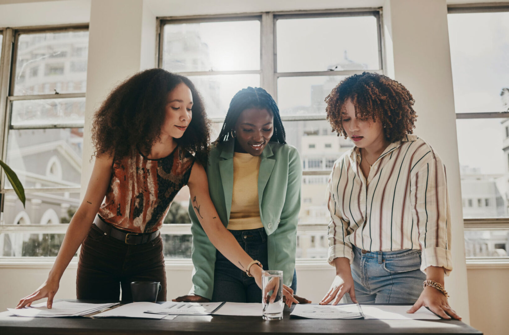 Three women collaborating on a project.